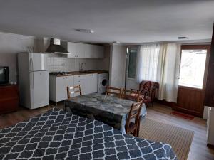 a kitchen and living room with a table in a room at Davids entire place in Borjomi