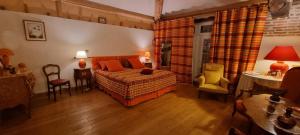 a bedroom with a bed and a table and chairs at Domaine de la Bellière in Villars-les-Dombes