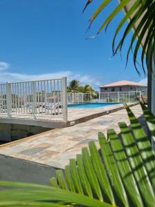 a boardwalk leading to a swimming pool with a white fence at Villa MALOEM in Sainte-Anne