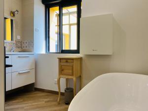 a small kitchen with a sink and a tub at Villa Kundalini - Guest House in Vincelles