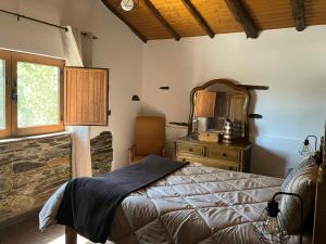 a bedroom with a bed and a dresser and a window at Quinta da Meda in Coimbra