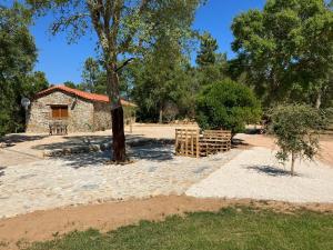 a building with a tree and a wooden fence at Quinta da Meda in Coimbra
