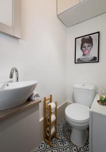 a bathroom with a white toilet and a sink at Aju Ben Yehuda 42 in Jerusalem