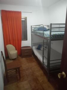 a bedroom with two bunk beds and a window at Miguel y Rosa Lúcar in Lúcar