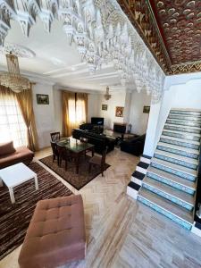 a living room with a staircase and a chandelier at Beautiful Villa Casablanca in Casablanca