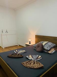 a bed with two plates on top of it at Rooms & Glamping Lana Haus in Ličko Petrovo Selo