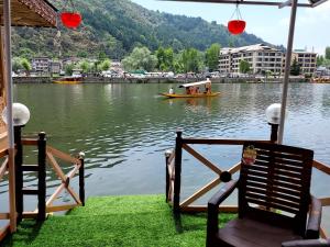 a boat in the water with a group of people on it at Tashkand Houseboat in Srinagar