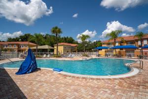 a large swimming pool with a blue tarp on it at JC DISNEY House in Kissimmee