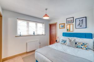 a bedroom with a blue bed and a window at Gorgeous 1-bed city apartment, sleeps 4, parking in Worcester