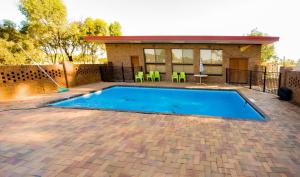 a swimming pool in the backyard of a house at Charlton Motel in Charlton
