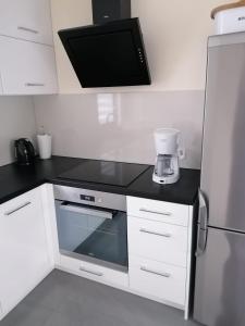 a kitchen with a black counter top and a blender at Willa nad morzem in Pobierowo