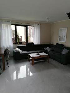 a living room with a couch and a coffee table at Willa nad morzem in Pobierowo +23 photos