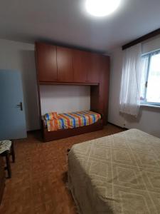 Postel nebo postele na pokoji v ubytování CasAngelica Alloggio indipendente con parcheggio interno