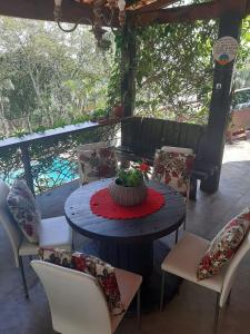 a table and chairs with a cake on top of it at Cantareira - Deck House in Mairiporã