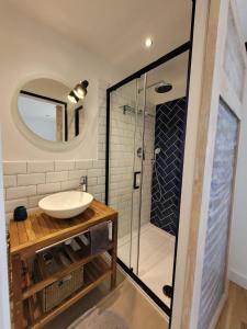 a bathroom with a sink and a glass shower at Domaine Mas de Galy in Saujac