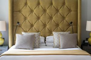 a bedroom with a large bed with two pillows at Bush Hotel Farnham in Farnham