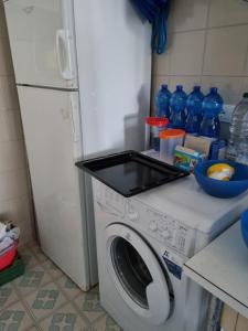 a washing machine with a stove top on top of it at Condomino Giuditta in Porto Santa Margherita di Caorle +16 photos