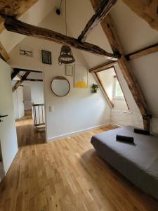 a bedroom with a bed in a attic at Domaine Mas de Galy in Saujac