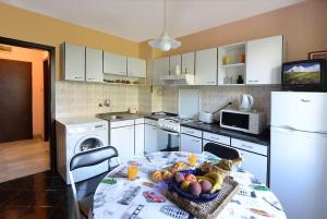 a kitchen with a table with a bowl of fruit on it at Beautiful location apartment in Sofia