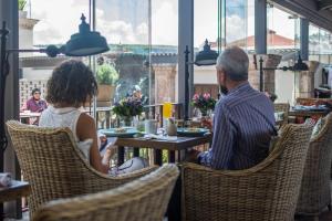un homme et une femme assis à une table dans un restaurant dans l'établissement Casa 1810 Hotel Boutique, à San Miguel de Allende