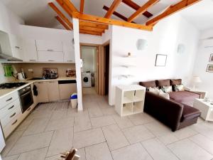 a kitchen and a living room with a couch at Sea - View in Himare +7 photos