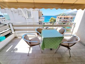 a table and chairs on a balcony with a view of the ocean at Sea - View in Himare