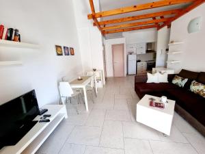 a living room with a couch and a table at Sea - View in Himare