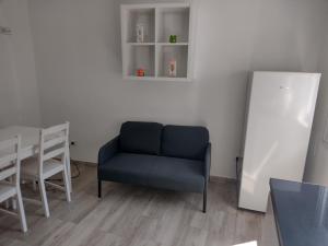 a living room with a blue chair and a table at De la Cuenca Mieres II con parking Privado in Mieres
