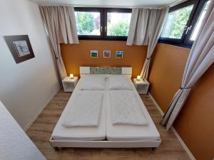 a bedroom with two beds in a room with windows at Mira in Winterberg