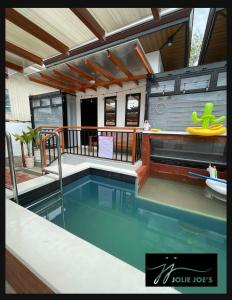 a tiny house with a swimming pool on a balcony at Jolie Joe's in Tagudin