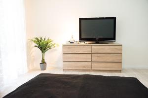 a television on a dresser in a living room at APARTMÁNY Fortuna in Vysoké Tatry
