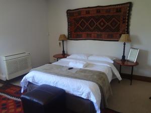 En eller flere senge i et værelse på Cape Panorama Lodge