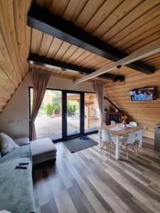 a living room with a bed and a table at Tana dell Lupo in Colibiţa