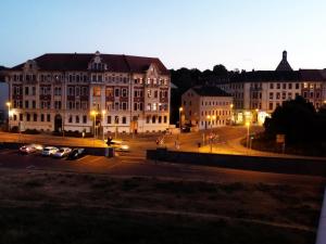 a view of a street with buildings at night at Hostel Meissen Old Town Bridge in Meißen
