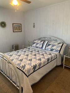 a bedroom with a bed with a blue and white comforter at Tombstone Bordello Bed & Breakfast in Tombstone