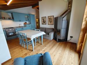 a kitchen and living room with a table and a couch at Casa Caravino in Varenna