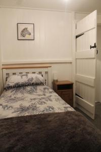 a bedroom with a bed and a dresser and a drawer at West View Cottage in Worcester