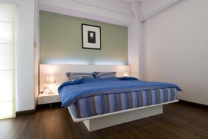 Säng eller sängar i ett rum på T Series Place Serviced Apartment