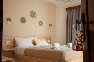 Postel nebo postele na pokoji v ubytování Arkasa Bay Hotel