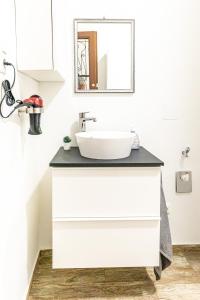 a bathroom with a white sink and a mirror at Premium City Apartment in Center of Vienna in Vienna