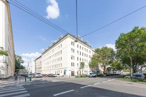 a large white building on a city street at Premium City Apartment in Center of Vienna in Vienna