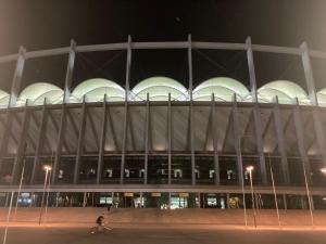 a large building with white domes at night at Royal Studio National Arena - Free Parking in Bucharest