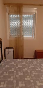 a bedroom with a bed and a window with blinds at Pozo de esparto in El Pozo del Esparto