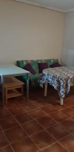 a living room with a table and a couch at Pozo de esparto in El Pozo del Esparto