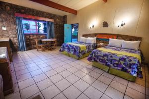 una camera d'albergo con due letti e un tavolo di Hotel Oasis a Loreto