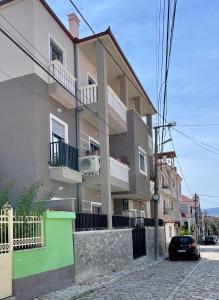 a building with a car parked in front of it at KeSa Apartment in Korçë