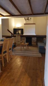 a living room with a piano and a couch at Holiday Cottage in Devon near Beaches and National Parks in Honiton