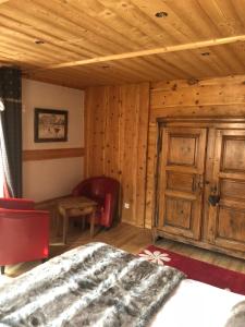 a bedroom with a bed and a wooden wall at Les Loft's de Mika in Briançon
