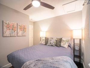 a bedroom with a bed and a ceiling fan at Homey Bungalow Convenient to Marietta and I-75! in Marietta