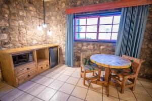 a dining room with a table and a tv at Hotel Oasis in Loreto